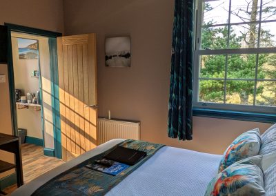 Bedroom with window looking out over garden